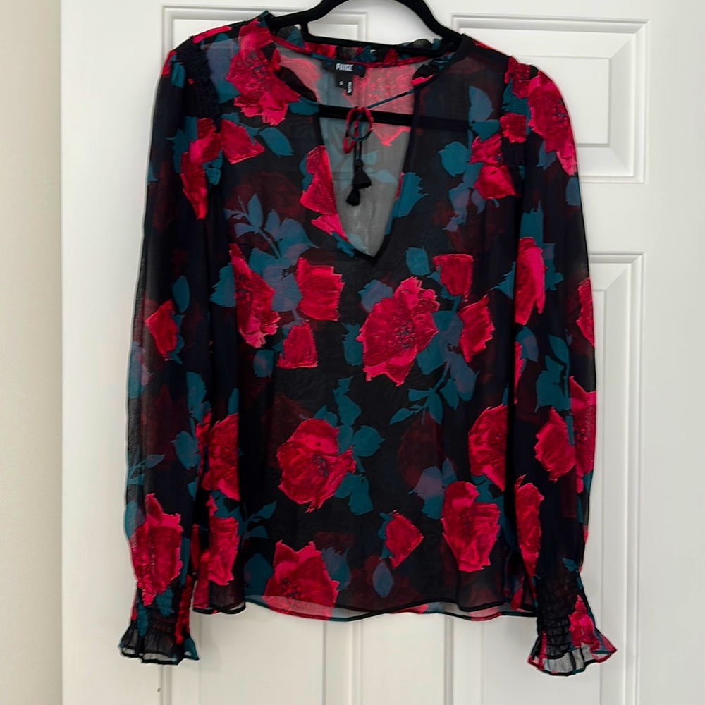 Beautiful floral blouse with bright flowers and a tie at the top